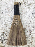 Black Pentacle Broom - Protection  This besom is a versatile handheld broom of stiff grass, bound with black cord and decorated with a silver Pentacle symbol charm.