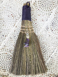 Purple Amethyst Goddess Broom - Feminine, Spiritual Connection  This besom is a versatile handheld broom of stiff grass, bound with purple cord and decorated with a silver Goddess symbol charm with Amethyst crystals.